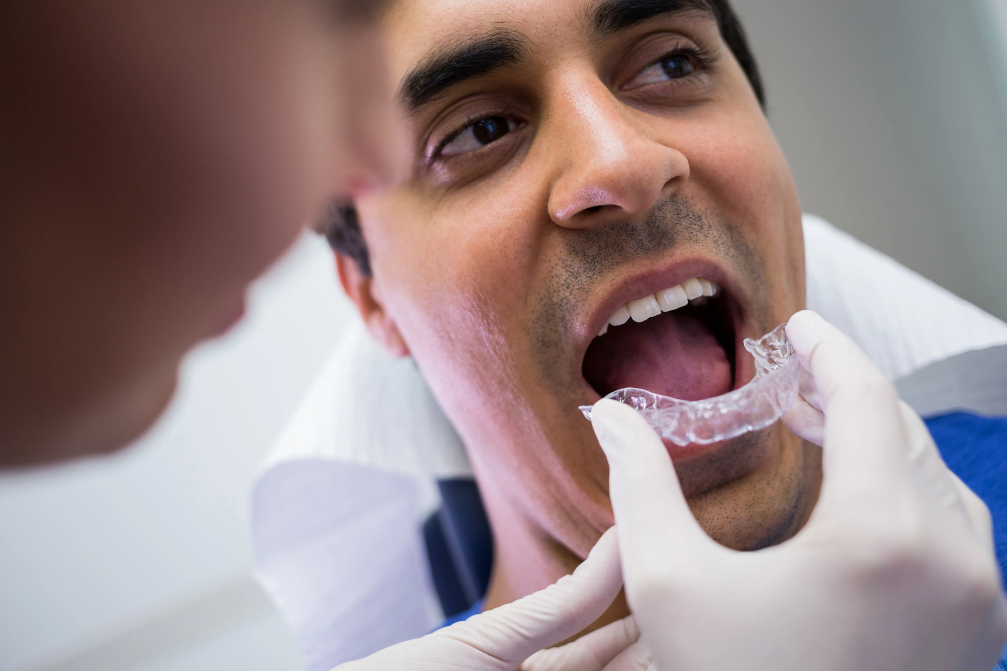 dentist-assisting-patient-wear-invisible-braces