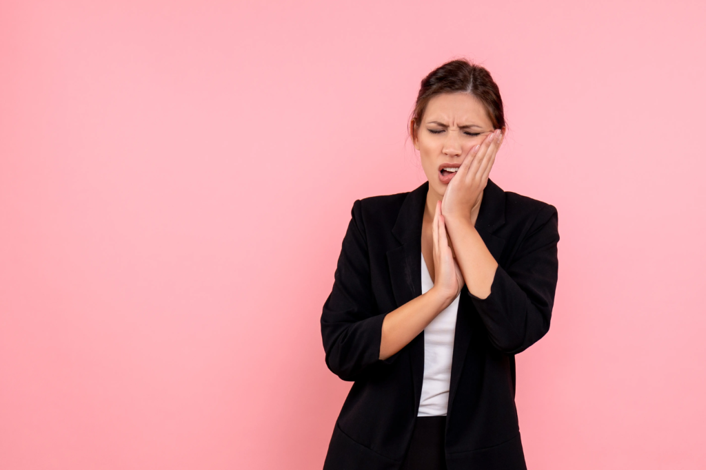 front-view-young-female-dark-jacket-having-toothache-pink-background