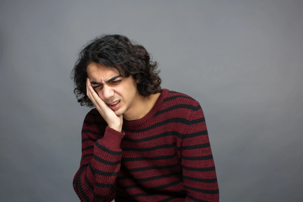 guy-have-headache-holds-head-with-hand